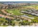 An aerial view of luxurious neighborhood homes adjacent to a well-manicured golf course, and tranquil lake at 9099 Hazard St, Davenport, FL 33896