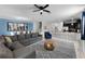 Spacious open-concept living area with a large sectional, modern furniture, and seamless flow to the kitchen and dining spaces at 9099 Hazard St, Davenport, FL 33896