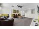 Living room with leather sofas, a ceiling fan, and a mounted television at 9099 Hazard St, Davenport, FL 33896