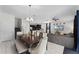 Open-concept living area with a large dining table, comfortable seating, and modern kitchen at 9099 Hazard St, Davenport, FL 33896