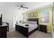 This main bedroom features a king bed, carpeted floor, and a ceiling fan for optimal comfort at 9099 Hazard St, Davenport, FL 33896