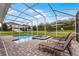 Relaxing screened in pool and spa, surrounded by a brick patio with lounge chairs, perfect for enjoying the outdoors at 9099 Hazard St, Davenport, FL 33896