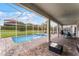 A refreshing screened in pool and spa, surrounded by a brick patio and ample seating, perfect for outdoor enjoyment at 9099 Hazard St, Davenport, FL 33896