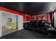 Home theater room with leather recliners, a large screen, and themed decor for the ultimate viewing experience at 9099 Hazard St, Davenport, FL 33896