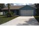 Exterior view of home with a two car garage and blue paint at 106 Sparrow Ct, Kissimmee, FL 34759