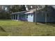 View of single-story home with blue exterior paint and lawn at 106 Sparrow Ct, Kissimmee, FL 34759