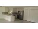 Bright kitchen featuring white cabinets, stainless steel appliances, and an island with bar seating at 106 Sparrow Ct, Kissimmee, FL 34759