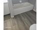 Bathroom featuring a new tub and wood-look floors at 1325 Dunbarton Ct, Kissimmee, FL 34758