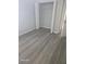This bedroom features an empty closet and modern, grey vinyl floors at 1325 Dunbarton Ct, Kissimmee, FL 34758