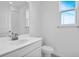 Bathroom featuring white vanity, toilet and shower with natural lighting at 2104 Riley Ave, Eagle Lake, FL 33839