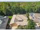 An aerial view showing the home's roof, landscaping, and proximity to the surrounding lush green trees at 350 Balboa Dr, Kissimmee, FL 34759