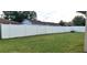 Large, private backyard enclosed by a pristine white fence, providing a secure space for recreation and relaxation at 449 Ball Ct, Kissimmee, FL 34759