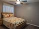 Comfortable bedroom featuring a floral-themed bed, a ceiling fan, and ample natural light from a window at 449 Ball Ct, Kissimmee, FL 34759