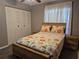 Charming bedroom features a floral bed, matching nightstands, and a spacious closet for ample storage at 449 Ball Ct, Kissimmee, FL 34759