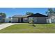 Charming single-story home with a well-manicured lawn and a concrete driveway at 449 Ball Ct, Kissimmee, FL 34759