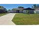 Charming single-story home featuring a well-manicured lawn and long driveway at 449 Ball Ct, Kissimmee, FL 34759