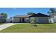 Inviting single-Gathering home with lush green lawn and a black front door at 449 Ball Ct, Kissimmee, FL 34759