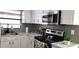 Contemporary kitchen featuring updated appliances and countertop at 449 Ball Ct, Kissimmee, FL 34759