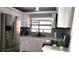 Stylish kitchen with stainless steel appliances, white cabinets, and ample counter space at 449 Ball Ct, Kissimmee, FL 34759