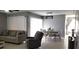 Open-concept living and dining area with ample natural light and tile flooring at 449 Ball Ct, Kissimmee, FL 34759
