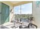 Screened balcony overlooking a pond and lush landscape at 8818 Dunes Ct # 306, Kissimmee, FL 34747