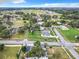 An aerial view shows a residential neighborhood with tree-lined streets and green spaces, highlighting community charm at 117 W Maple St, Davenport, FL 33837