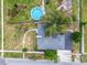 Aerial view of a well-maintained single-Gathering house featuring a pool and lush, green landscaping at 117 W Maple St, Davenport, FL 33837