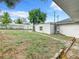 A large, fenced backyard with a sturdy, cement block foundation bordering the residence and space for customization at 117 W Maple St, Davenport, FL 33837
