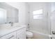 A bright bathroom features a tub, a window, a sink and tiled walls at 2507 Monaco Cove Cir, Orlando, FL 32825