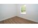 This bright bedroom has hardwood floors, base trim and a window with outside views at 2507 Monaco Cove Cir, Orlando, FL 32825