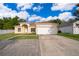 Charming single-story home with attached two-car garage, landscaped yard, and well-maintained lawn at 2507 Monaco Cove Cir, Orlando, FL 32825