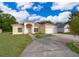 Inviting single-level home with a well-maintained lawn, arched entryway, and attached two-car garage at 2507 Monaco Cove Cir, Orlando, FL 32825