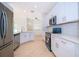 Modern kitchen featuring white cabinetry, stainless steel appliances, and stylish backsplash at 2507 Monaco Cove Cir, Orlando, FL 32825