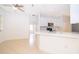Modern kitchen with white cabinets, stainless steel appliances, and breakfast bar seating at 2507 Monaco Cove Cir, Orlando, FL 32825