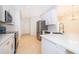 Modern kitchen with white cabinets, stainless steel appliances, and breakfast bar seating at 2507 Monaco Cove Cir, Orlando, FL 32825
