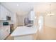 Modern kitchen with white cabinets, stainless steel appliances, and breakfast bar seating at 2507 Monaco Cove Cir, Orlando, FL 32825