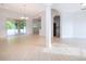 Bright, open-concept living space with neutral tile flooring and an abundance of natural light from sliding glass doors at 2507 Monaco Cove Cir, Orlando, FL 32825