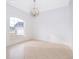 Empty living room featuring neutral paint, tile floors, a large arched window, and modern light fixture at 2507 Monaco Cove Cir, Orlando, FL 32825