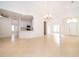 Open-concept living space showcases neutral tile flooring, white walls, and adjoining kitchen at 2507 Monaco Cove Cir, Orlando, FL 32825