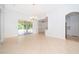 Open living space features neutral tile, sliding doors to patio, and decorative chandelier at 2507 Monaco Cove Cir, Orlando, FL 32825