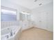 A luxurious bathroom has tiled floors, a soaking tub, white walls, and double sinks at 2507 Monaco Cove Cir, Orlando, FL 32825