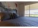 Comfortable bedroom features a plush bed with patterned pillows and a bright window view at 5245 W Irlo Bronson Memorial Hwy # 244, Kissimmee, FL 34746