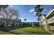 Building exterior with grassy courtyard, palm trees, and blue sky at 5245 W Irlo Bronson Memorial Hwy # 244, Kissimmee, FL 34746