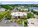 Aerial shot showcases building's setting by a serene lake in a neighborhood with mature trees at 544 Orange Dr # 10, Altamonte Springs, FL 32701