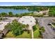 Aerial view of building surrounded by lake and landscaping at 544 Orange Dr # 10, Altamonte Springs, FL 32701