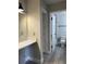 Bathroom featuring gray wood look flooring, vanity and marble shower walls visible through open door at 544 Orange Dr # 10, Altamonte Springs, FL 32701