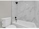 Modern bathroom featuring a toilet and marble tiled shower with black fixtures at 544 Orange Dr # 10, Altamonte Springs, FL 32701
