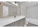 Modern bathroom featuring a gray vanity with white countertop, toilet, and marble tiled shower at 544 Orange Dr # 10, Altamonte Springs, FL 32701