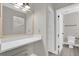 Bright bathroom featuring modern vanity, quartz counters, and walk in closet at 544 Orange Dr # 10, Altamonte Springs, FL 32701