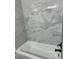 Modern bathroom featuring a sleek bathtub with gray marble tile walls and black fixtures at 544 Orange Dr # 10, Altamonte Springs, FL 32701